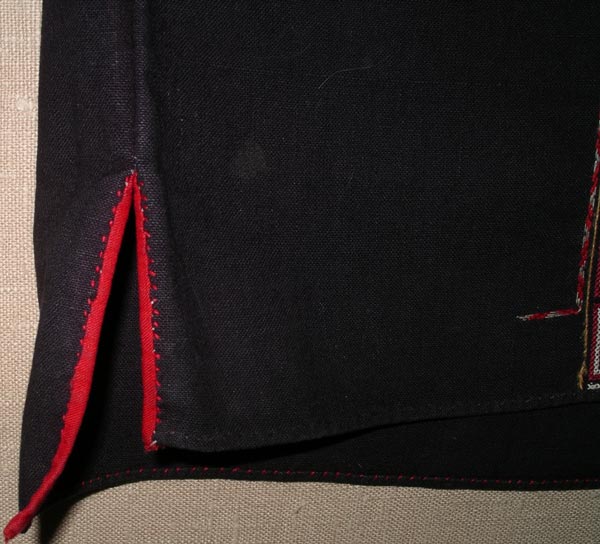 Jpeg 56K Detail of side vent (with the front facing the camera) on a Qi Li woman's embroidered blouse purchased in 2005 in in the style of those from Changjiang in Hainan Island