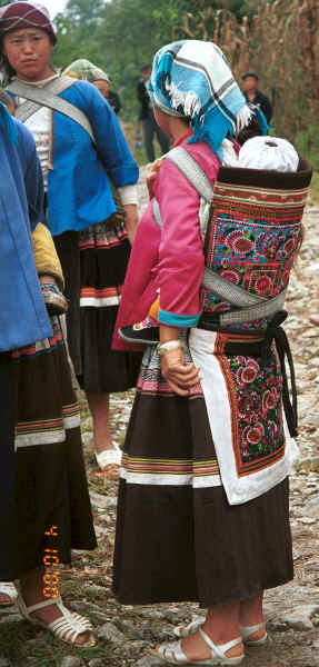 Side comb Miao women showing off their babies in beautifully decorated carriers - note the fine embroidery - Long Dong village, De Wo township, Longlin country, Guangxi province 0010d28.jpg