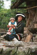 Jpeg 35K Side comb Miao woman and baby in their festival finery, Long Dong village, De Wo township, Longlin country, Guangxi province 0010e09.jpg