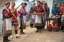 to Jpeg 104K Miao women greeting us with alchohol, small carved charms and lusheng pipe music as we enter Lou Jia Zhuang village, Anshun city, Guizhou province. 0110A18