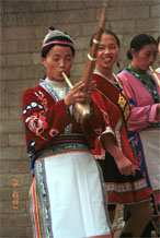 to Jpeg 65K Miao women greeting us with lusheng pipe music as we enter Lou Jia Zhuang village, Anshun city, Guizhou province 0110A23