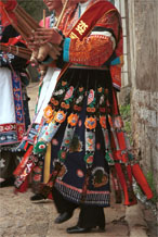 to Jpeg 105K This Miao woman has a skirt and silver head dress which is not local to this area. It may have been adopted to create more of a stir in the dance competitions or she might have maried into the village from elsewhere. Lou Jia Zhuang village, Anshun city, Guizhou province.