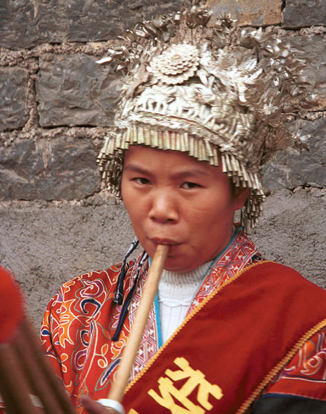 Jpeg 103K This Miao woman has a skirt and silver head dress which is not local to this area. It may have been adopted to create more of a stir in the dance competitions or she might have maried into the village from elsewhere. Lou Jia Zhuang village, Anshun city, Guizhou province. 0110A33