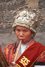 to Jpeg 103K This Miao woman has a skirt and silver head dress which is not local to this area. It may have been adopted to create more of a stir in the dance competitions or she might have maried into the village from elsewhere. Lou Jia Zhuang village, Anshun city, Guizhou province. 0110A33