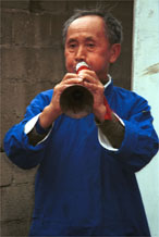 to Jpeg 46K One of the welcoming musicians at the entrance to Lou Jia Zhuang village, Anshun city, Guizhou province 0110A37