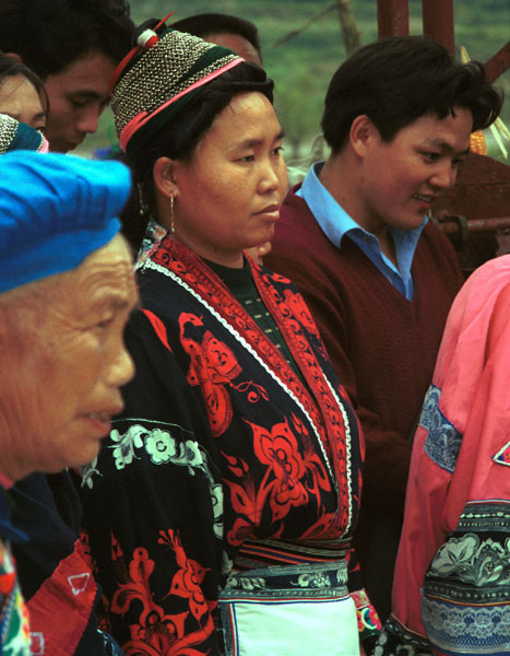 Jpeg 86K Miao woman wearing her wax resist (batik) indigo and red dyed jacket. Note her traditional hair style. Lou Jia Zhuang village, Anshun city, Guizhou province 0110B14 