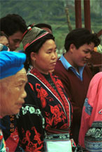 to Jpeg 86K Miao woman wearing her wax resist (batik) indigo and red dyed jacket. Note her traditional hair style. Lou Jia Zhuang village, Anshun city, Guizhou province 0110B14 