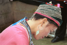 to Jpeg 75K Miao woman concentrating on her wax resist. Note her traditional hair style (and a la dio (wax knife) tucked in her hair near the circular (red) comb. Lou Jia Zhuang village, Anshun city, Guizhou province 0110B21