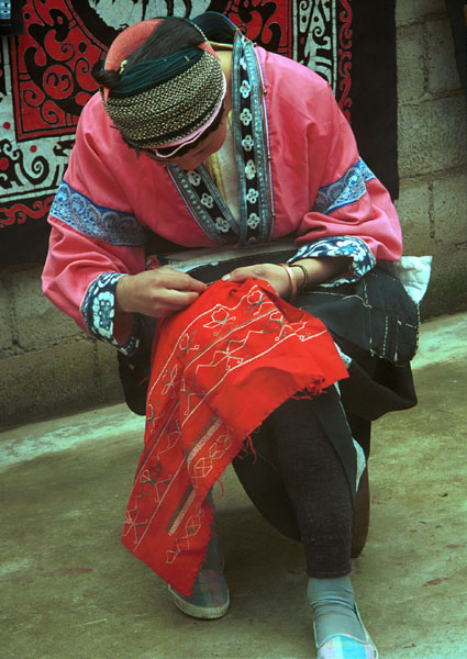 Jpeg 86 Miao woman wearing her festival clothing working on embroidery. Lou Jia Zhuang village, Anshun city, Guizhou province 0110B22