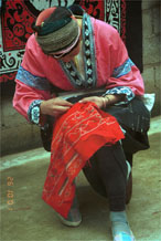 Jpeg 86 Miao woman wearing her festival clothing working on embroidery. Lou Jia Zhuang village, Anshun city, Guizhou province 0110B22