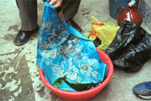 to Jpeg 120K Taking the wax resist fabric out of the indigo dye bath after its first dyeing. Note the bright turquoise blue as it emerges before it goes a greenish hue as it oxidises. Lou Jia Zhuang village, Anshun city, Guizhou province 0110B30