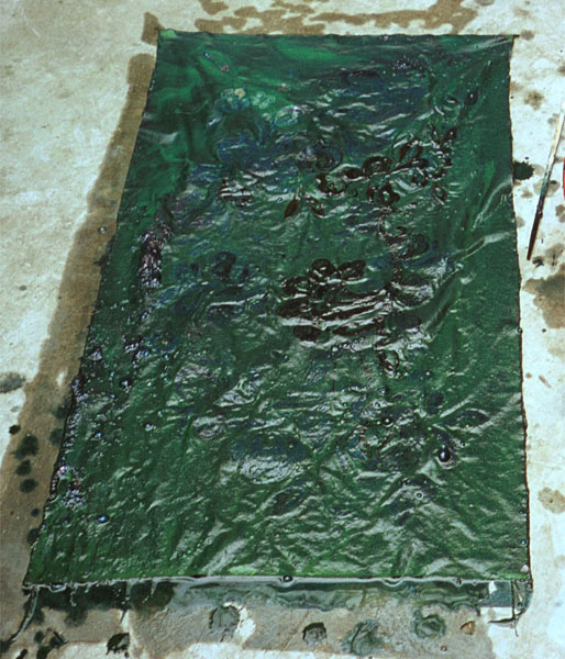 Jpeg 110K The wax resist fabric, having been out of the indigo dye bath from its first dyeing and starting to oxidise, has now gone a greenish hue. Lou Jia Zhuang village, Anshun city, Guizhou province 0110B31 