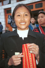 to Jpeg 64K Miao woman holding a strip of her hand embroidery which I have just purchased. Lou Jia Zhuang village, Anshun city, Guizhou province. 0110B36