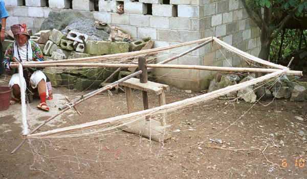 White Miao woman checking the hemp or ramie thread for breaks during the processing of the thread - Ma Wo village 0010j08.jpg