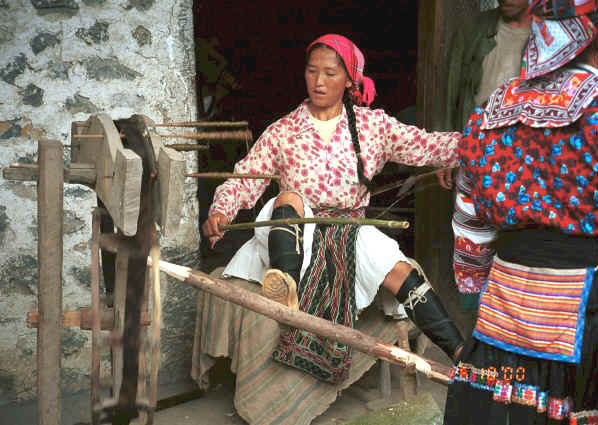 White Miao woman spinning 5 reels of hemp or ramie onto spindles after initial splicing - Ma Wo village, Zhe Lang township, Longlin county, Guangxi province 0010j12.jpg