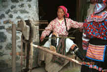 Jpeg 43K White Miao woman spinning 5 reels of hemp or ramie onto spindles after initial splicing - Ma Wo village, Zhe Lang township, Longlin county, Guangxi province. 0010j12.jpg