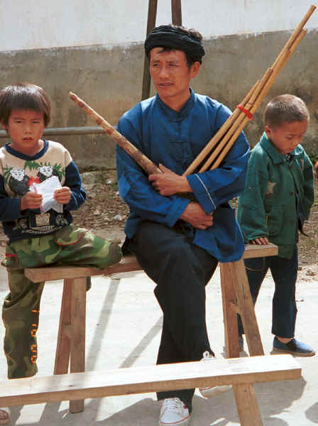 Musician with his lushen pipes and two small boys - Sha Jiao village, Wan Teng township, Xingyi metropolitan area, Guizhou province 0010m25.jpg
