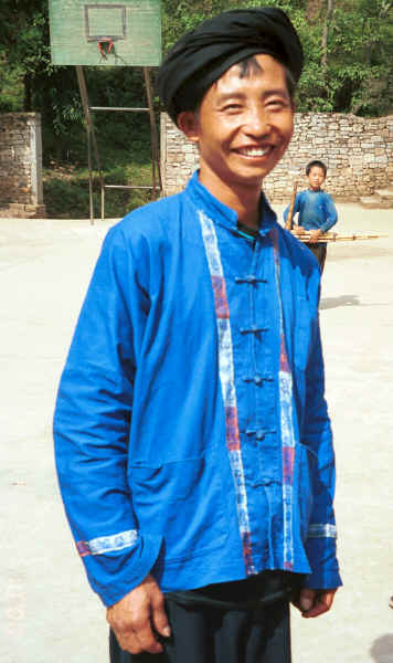 One of the musicians who has given his lushen pipes to the small boy behind him who wanted to play them - Sha Jiao village, Wan Teng township, Xingyi metropolitan area, Guizhou province 0010m26.jpg