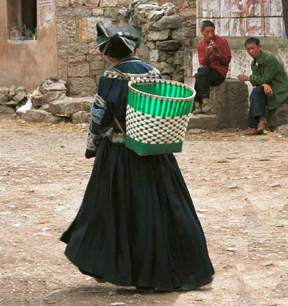 Old Bouyei woman walking through the village open area - Shitou village, Huanggousu township, Zhen Nin county, Guizhou province 0010u06A.jpg