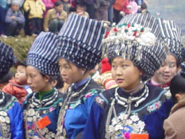 Jpeg 45K A group of Miao girls in their festival finery including the striking woven turbans 6 -10 metres in length in a village in Songtao Miao Autonomous County, Tongren Prefecture, eastern Guizhou Province.