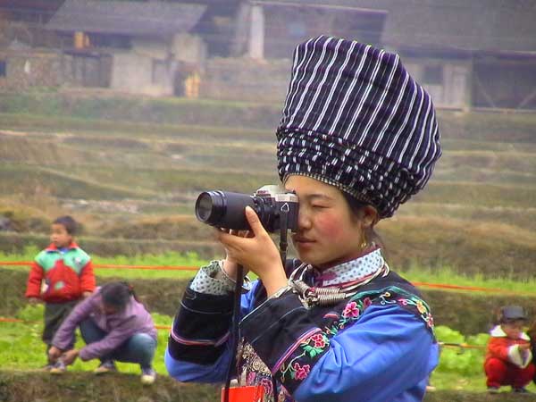 Jpeg 37K Miao girl dressed in her festival finery testing the camera in a village in Songtao Miao Autonomous County, Tongren Prefecture, eastern Guizhou Province.