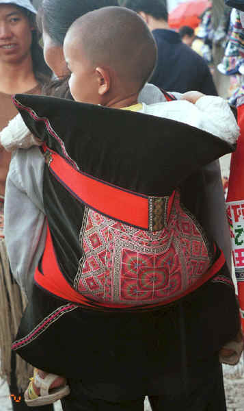 Sani baby in a traditional embroidered baby carrier - Stone Forest, Shilin, Stone Forest county, Yunnan province 0010b05.jpg