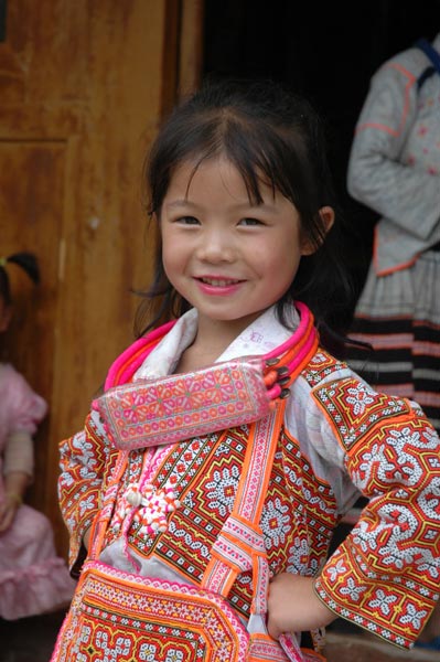 Jpeg 59K Young Long Horned Miao girl showing off her beautifully embroidered festival costume.