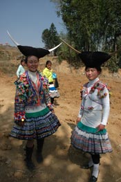 to Jpeg 64K White Miao girls in festival dress at the White Miao Dance Flower festival near Dafang in April 2007