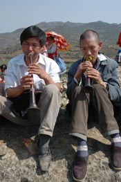 to Jpeg 66K White Miao men playing suona at the Dance Flower festival near Dafang in April 2007