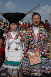 to Jpeg 67K White Miao girls in festival dress at the White Miao Dance Flower festival near Dafang in April 2007