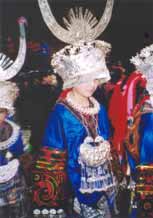 to Jpeg 56K E14e Tony's girlfriend  resplendent in her festival costume dancing on 29 February 2004, Langde village, Guizhou province