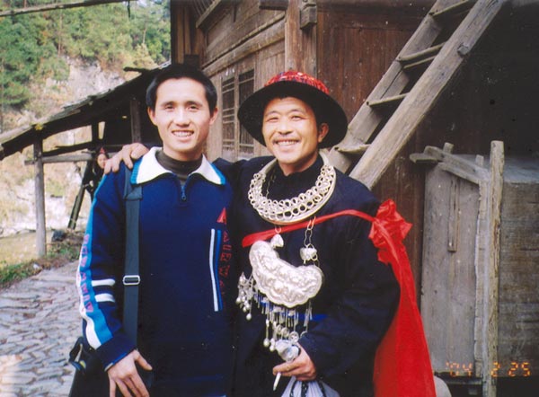 Jpeg 53K E16e Tony Chen with the Shaman on 25 February 2004, the fourth day of the festival, when the spirit of the Mountain Dragon was taken into each house in the village by the Shaman and the leading men of Langde village, Guizhou province