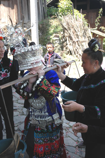 73K Jpg image The bride carrying the water to the groom's house