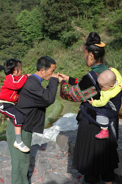 72K Jpg image Tony's aunt, wearing festival clothes, offering rice wine to his elder sister's father-in law