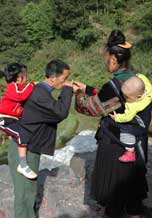 to 72K Jpg image Tony's aunt, wearing festival clothes, offering rice wine to his elder sister's father-in law