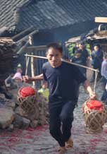 to 69K Jpg image The rice wine given by Tony's older sister being carried up to the village