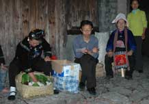 to 63K Jpg image Female villagers giving a little money, rice, eggs and so on. They receive steamed sticky rice and a meal.