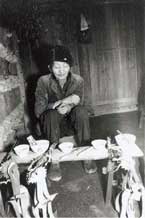 to Jpeg 46K A Miao shamna carrying out a ceremony