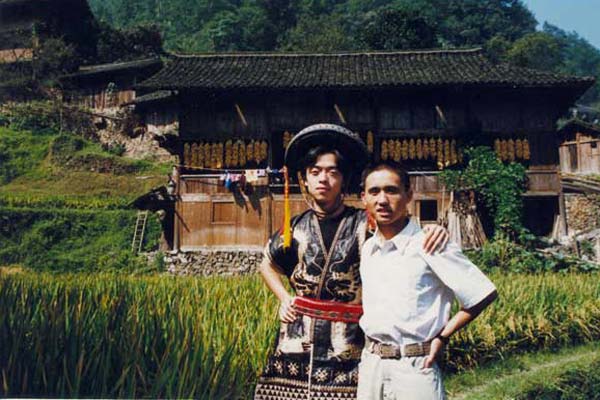 Jpeg 50 K Tony Chen Hualong with a former colleague against the background of Tony's house and fertile paddy fields