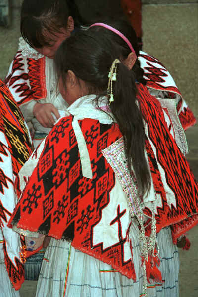 Big Flower Miao girls in festival finery showing the cape which is woven with wool and then fabric appliqud onto the wool - Xian Ma village, Hou Chang township, Puding county, Guizhou province 0010x18.jpg