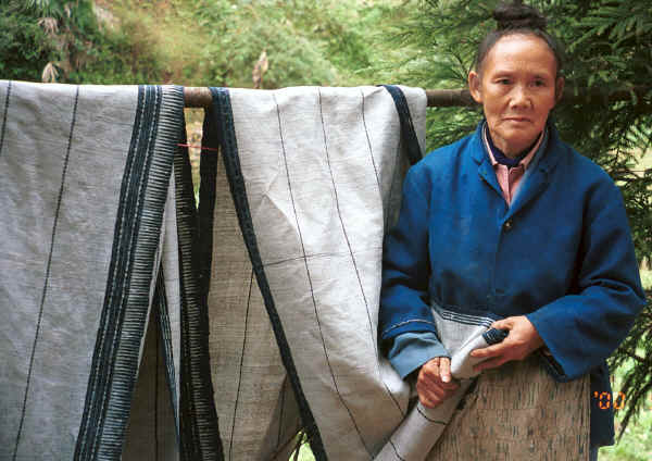 Li Jiang Ying, a Big Flower Miao woman who is 60 years old and had been taught at a missionary school, was the maker of both these two skirt lengths - the one on the left of the photo is made from ramie and the one on the right is hemp.  The indigo design on both has been created via a batik wax resist with the wax being applied to both sides of the fabric completely covering all the white areas of fabric. Xian Ma village, Hou Chang township, Puding county, Guizhou province 0010y12.jpg