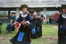 Jpeg 45K Young Black Miao girls dressed in their festival finery dancing. Zuo Qi village, Min Gu township, Zhenfeng county, Guizhou province 0010p25.jpg