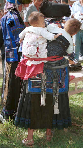 Black Miao woman minding two babies with one in a beautifully embroidered baby carrier, Zuo Qi village, Min Gu township, Zhenfeng county, Guizhou province 0010q07.jpg