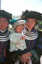 Jpeg 35K Black Miao young women with baby all in their festival finery, Zuo Qi village, Min Gu township, Zhenfeng county, Guizhou province 0010q22.jpg