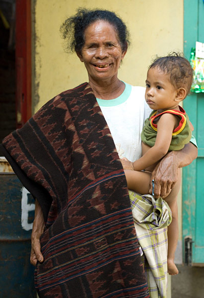 Theorara Gelu with a young relative and the sarong she dyed and wove herself, with a manta ray motif. Handspun cotton and natural dyes. Lamalera