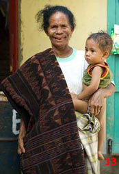 to 71K Jpg - Theorara Gelu with a young relative and the sarong she dyed and wove herself, with a manta ray motif. Handspun cotton and natural dyes. Lamalera