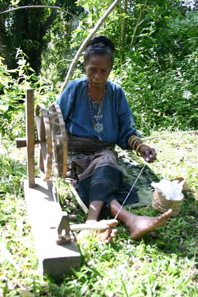 57K Jpeg 0185 Spinning cotton thread - one of the weavers of Watublapi, Flores, who use homegrown cotton and natural dyes for their weaving, showing their traditional weaving skills (2004).