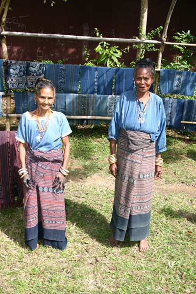 56K Jpeg 0197 Two of the weavers of Watublapi, Flores, who use homegrown cotton and natural dyes for their weaving, in front of some of their textiles (2004).