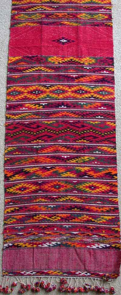 Jpeg 97K A modern cotton supplementary weft woven pha chet purchased in northern Thailand in 1988 - and probably woven during that decade. The bright dyes are very clearly chemical but the weaving is very fine.