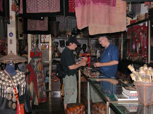 Jpeg 57K  Bucklee Bell with a customer in his side of the gallery 'Kesorn Arts' which he runs with his wife Kesorn Bell in Chiang Mai 3397